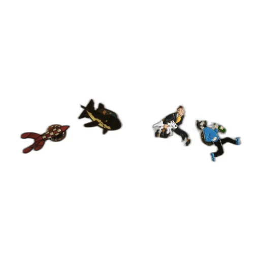 Lot de 4 pin's Tintin posés sur un tissu : fusée