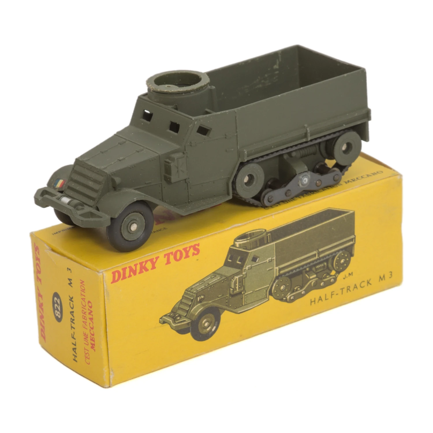 Miniature militaire Dinky Toys 822 Half-Track M3 vert posée sur sa boîte d