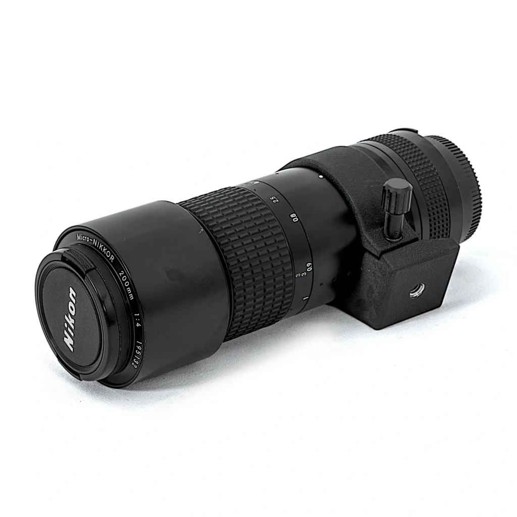 Objectif Nikon Micro-Nikkor 200mm f/4 IF AI-S posé à plat avec son collier de pied