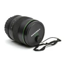 Objectif Hanimex HMC 135mm f/2.8 avec son bouchon avant