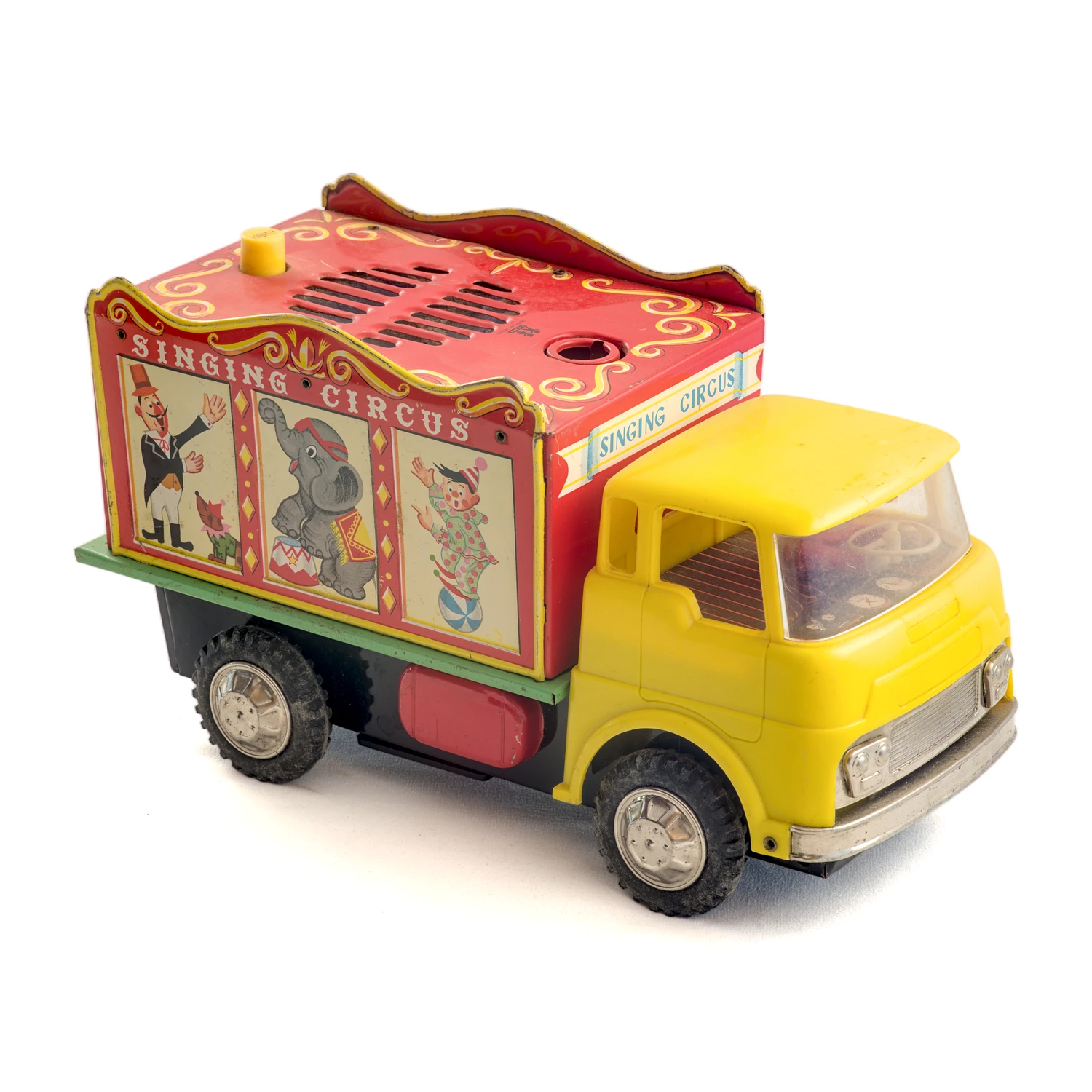Camion jouet ancien Tomy Singing Circus de profil