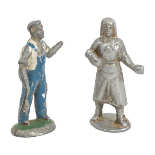 Vue de face de deux figurines anciennes en plomb représentant un fermier en salopette bleue et une paysanne