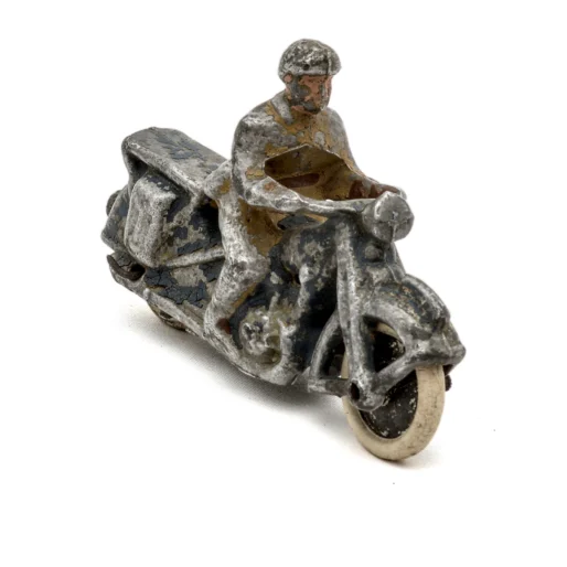 Figurine ancienne motard sur moto en métal coulé profil gauche