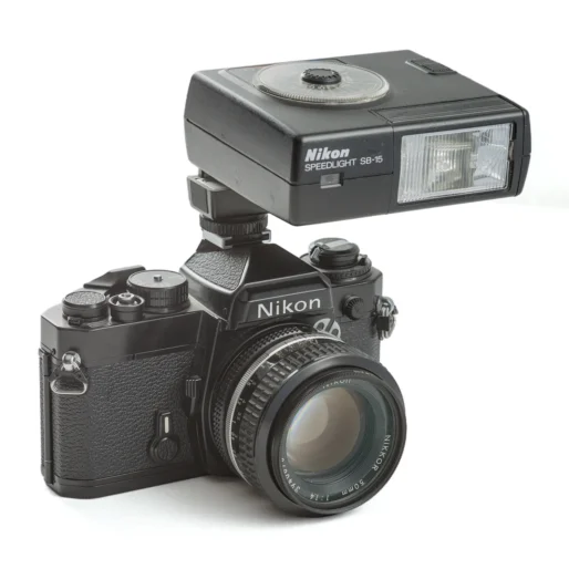 Appareil photo reflex argentique Nikon FE noir avec flash SB-15 monté sur la griffe